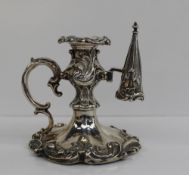 A Victorian silver taper stick, the removable sconce decorated with leaves and scrolls, the base