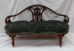 A Victorian walnut framed two seater settee, the back with leaf and scroll decoration above a pad