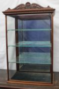 An Edwardian mahogany table top display cabinet, with a shell carved cresting rail, glazed front and