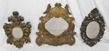 A gilt decorated wall mirror with a floral and swag cresting above figures and roses, 53cm high x