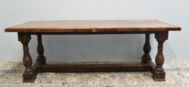 An 18th century style oak refectory table, the planked rectangular top on four ring turned