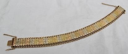 A yellow and white bi-metallic bracelet, with bark effect, approximately 34 grams