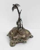A Victorian silver table centrepiece in the form of an island with palm trees on the centre, London,