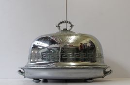 An electroplated domed food cover and base, the lid with a central handle, with scrolling and leaf