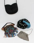 A beadwork decorated purse together with another bead decorated purse, a silver purse and an