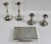 A pair of George V silver desk candlesticks with ring turned columns and a spreading foot, London,