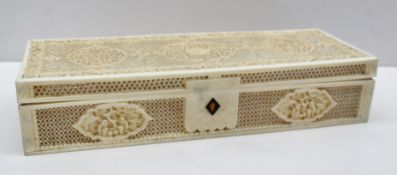 A Chinese ivory glove box of rectangular form, with carved panels of figures in landscapes between