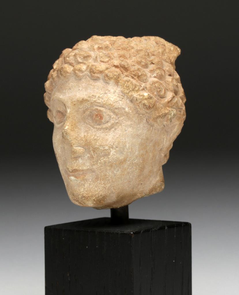 Cypro-Archaic Limestone Head of a Youth   Cyprus, ca. 600 BCE. With cap-like hairdo of snail