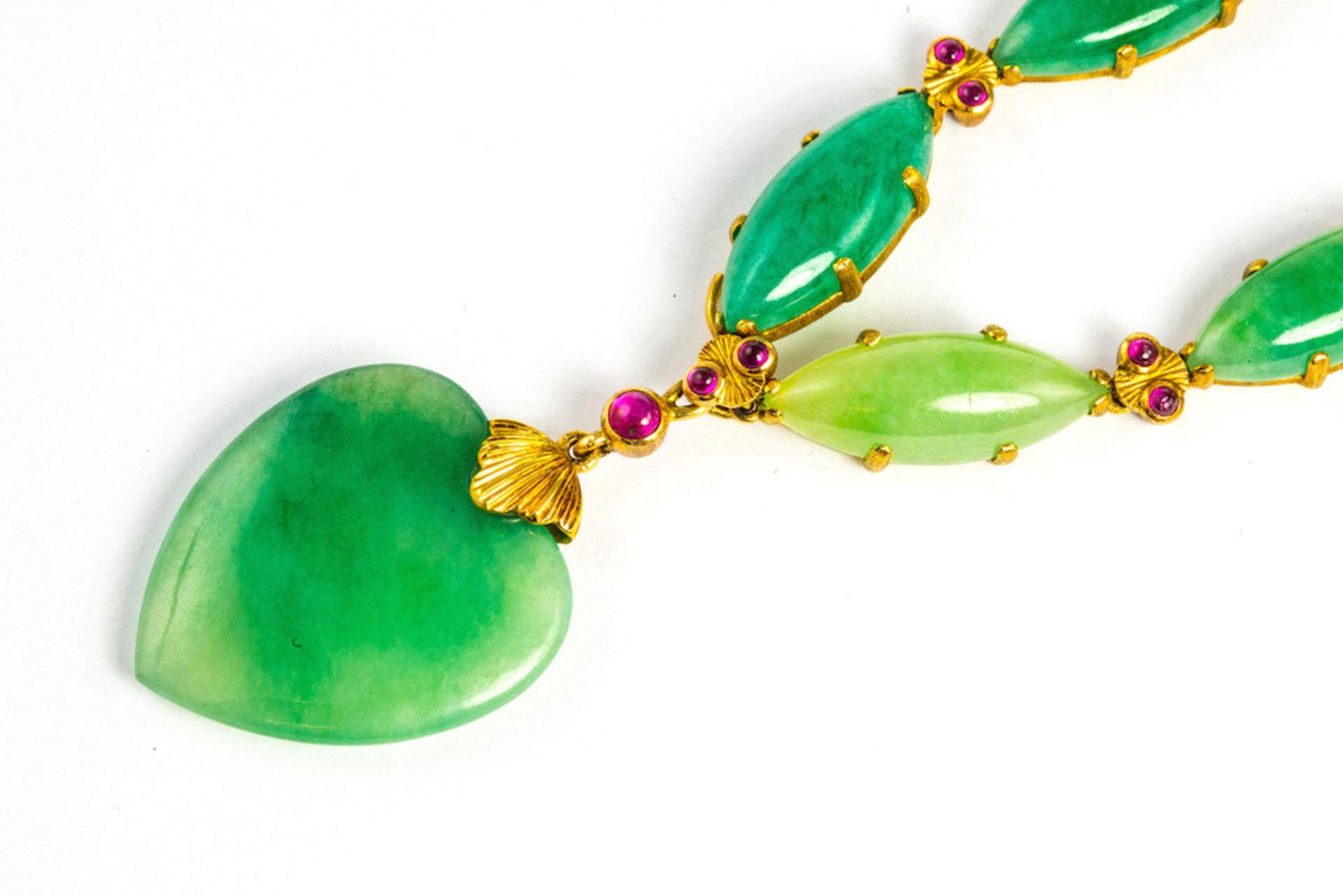 BUCCELLATI JADE AND RUBY GOLD NECKLACE - centering upon a heart shaped jadeite drop, suspended from