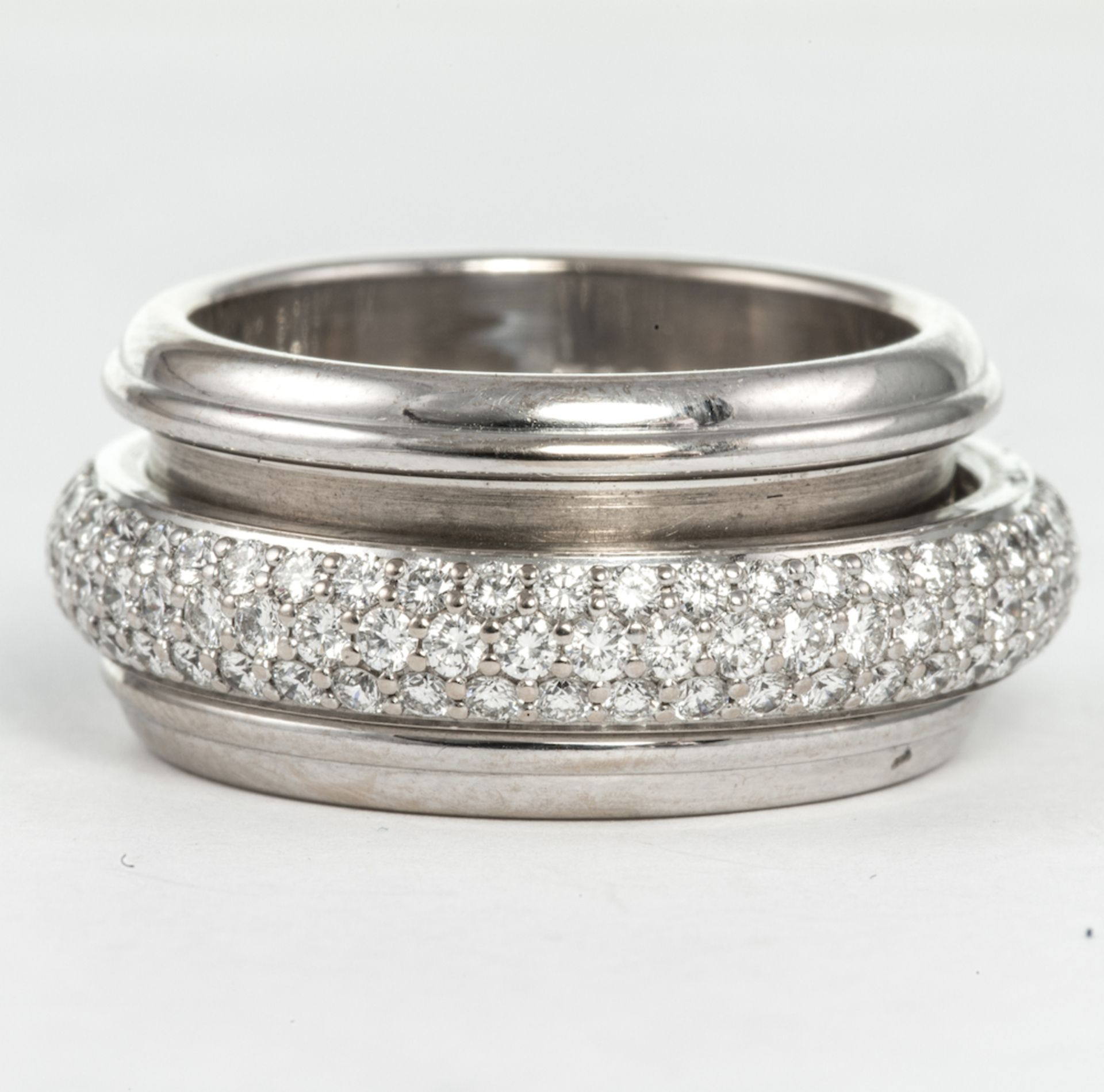 PIAGET - a diamond band ring, the rotating central band pave-set with brilliant cut diamonds, to