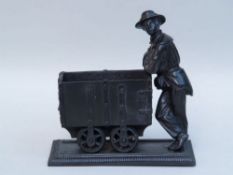 Miner figure leaning against a wagon - Berliner Eisen/Berlin Iron, mid 19th century, a black