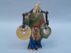 Lucky Deity - China, 20th century, shouldering an oversized peach and a lucky coin, clay figure,