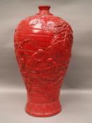 Large Meiping Vase -  China, covered with red glaze, overall decorated with moulded depictions of