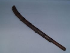 Blow mace - probably South Seas, wood with twisted iron rod and brackets, approximately 72cm L.