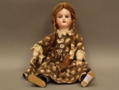 Porcelain head doll - marked Armand Marseille AM 390, mass joint body, clothed, approximately 29cm