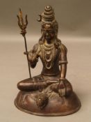 Shiva - India, 20th century, bronze cast, depicted in seated position on tiger skin over domed base,