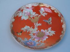 Plate - Japan, Satsuma, decorated with peonies and butterflies on red ground, irregular gilt border,