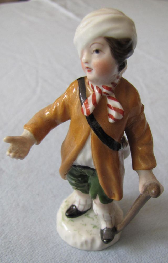 Porcelain figure, KPM Berlin. Angel with walking stick.  9 cm high. Signs of wear and restorations.