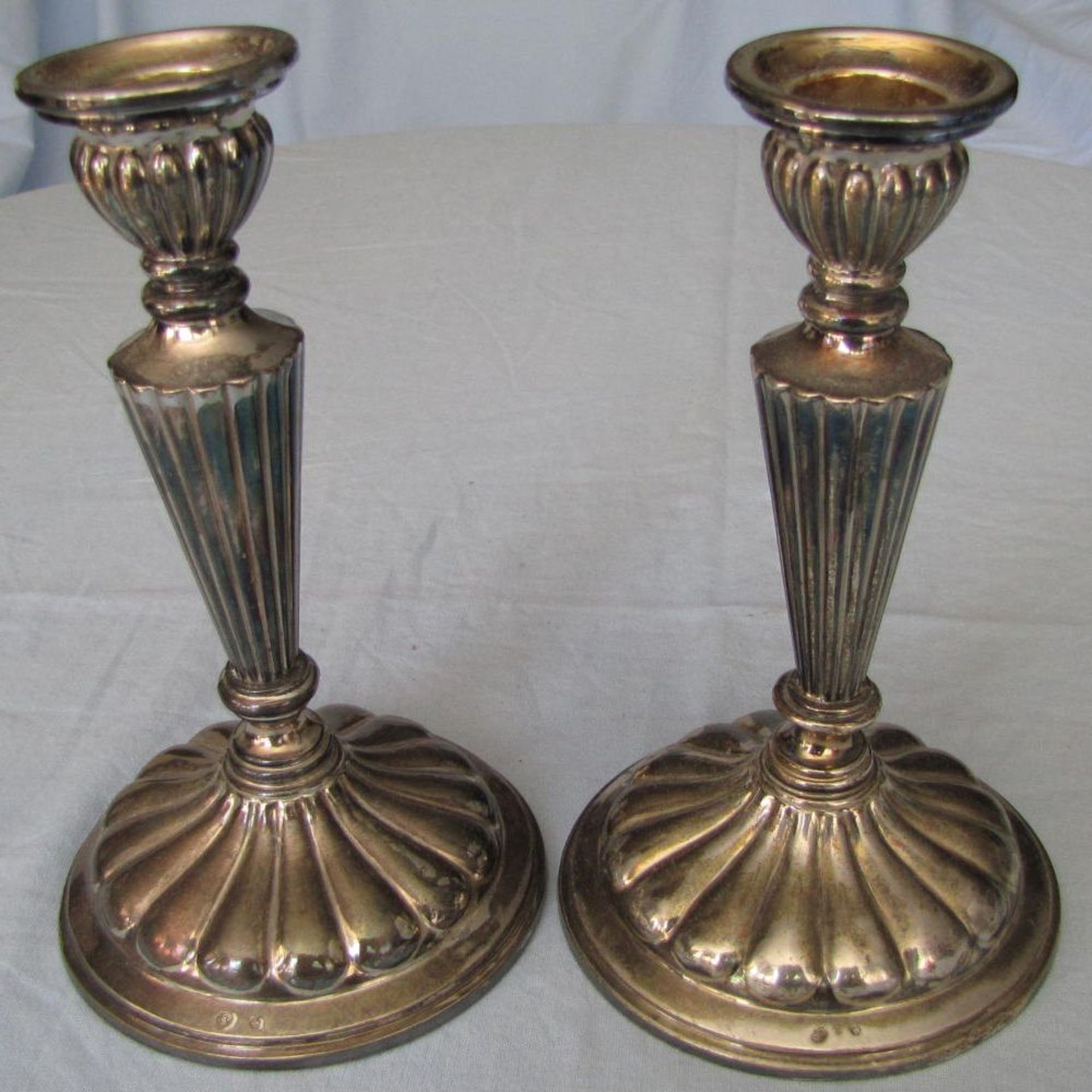 2 candle sticks. Silver. Hallmarked with a star.  488 grams gross. 17 cm high. Filled stands. In