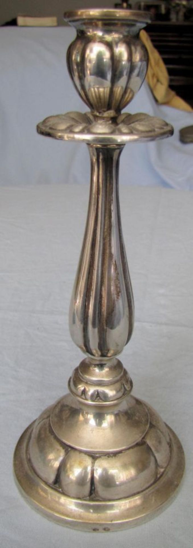 A silver candlestick. Art Nouveau. Marked.  21.5 cm high. 255 grams gross. Filled stand. Silver