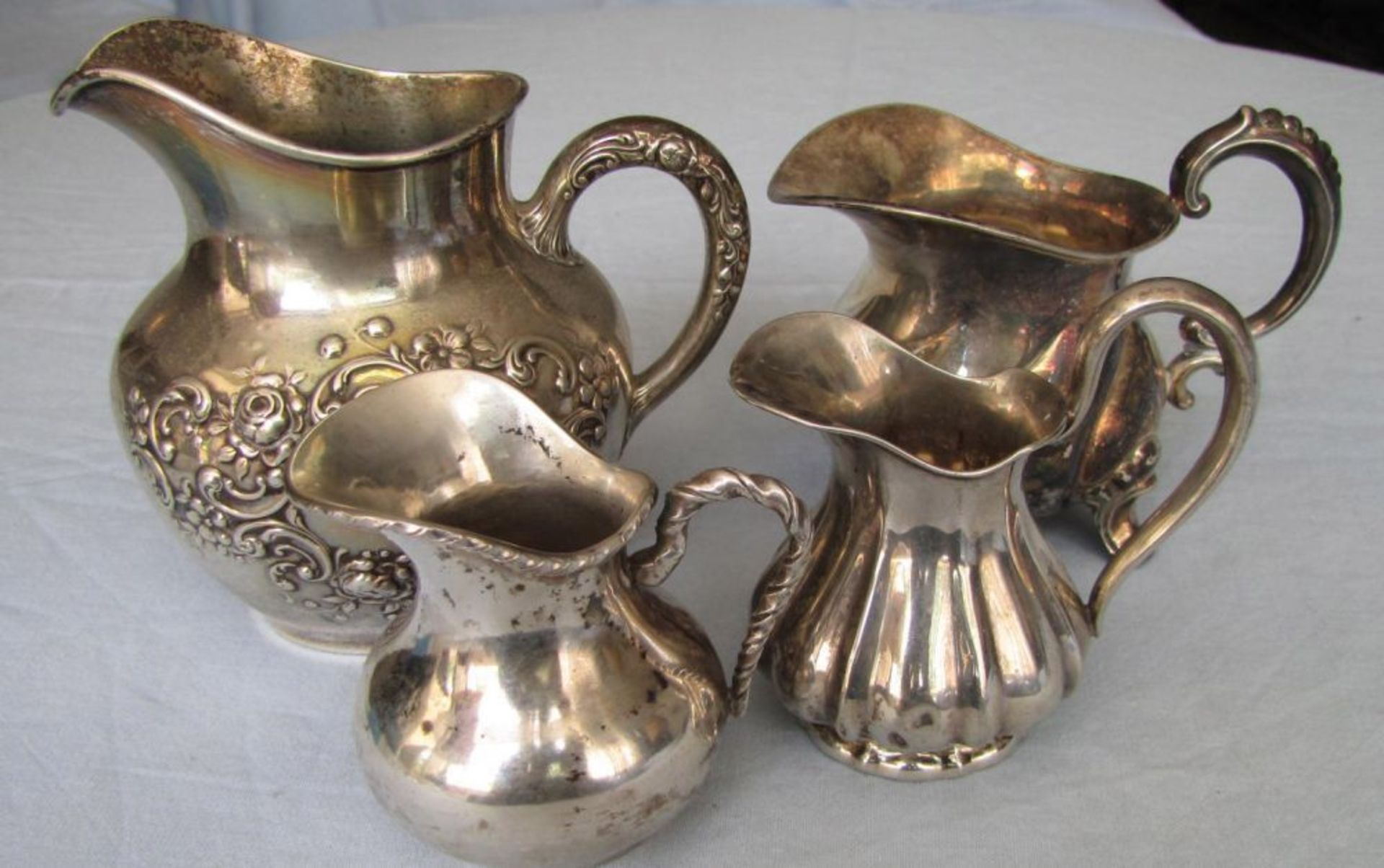 4 silver jugs. 422 grams total.  To 11.5 cm high. Up to 925 silver content. Handles filled?