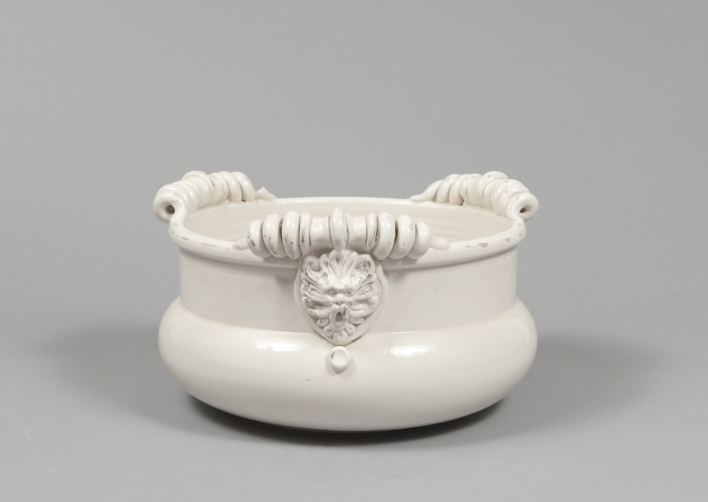 CERAMIC CASHPOT, 80S  entirely in white enamel, lion heads with loops and spirals.  Unmarked.