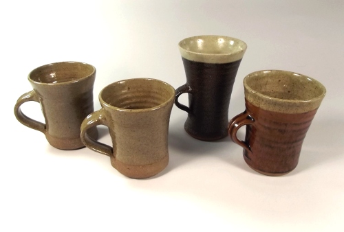 LEACH POTTERY ETC,
A Leach Pottery mug, a Lowerdown Pottery mug & two mugs marked 'TP'.