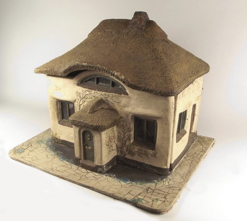 DOLLS HOUSE.
A vintage, moulded plaster doll's house with removable front, on painted wooden base.