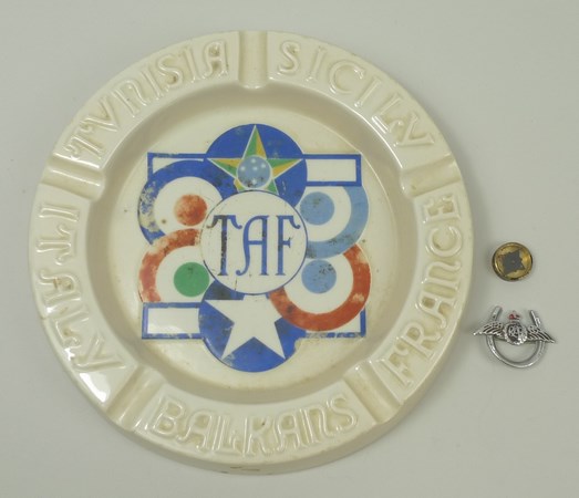 A WWII RAF escape compass, an RAF horseshoe sweetheart brooch, and an ashtray with TAF to centre for