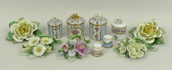 A group of five Dresden porcelain floral ornaments, four cylindrical boxes and covers with floral