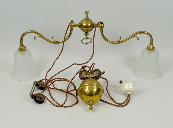 A 1920's brass twin ceiling light, the opaque glass shades, 72 by 14 by 30cm high, with original