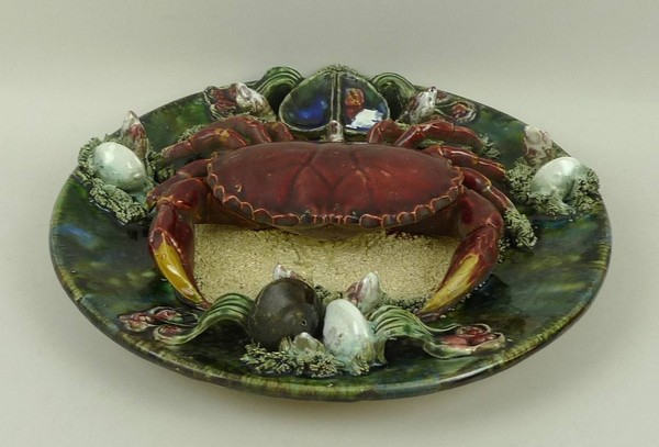 A Portuguese Palissy style dish, 20th century, modelled with a crab surrounded by shells and