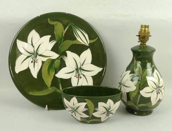 A Moorcroft pottery dish decorated in the 'Bermuda Lily' pattern, 30cm diameter, together with a