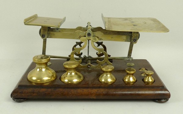 A 19th century burr walnut and brass set of scales, the base with graduated weights from ½lb to