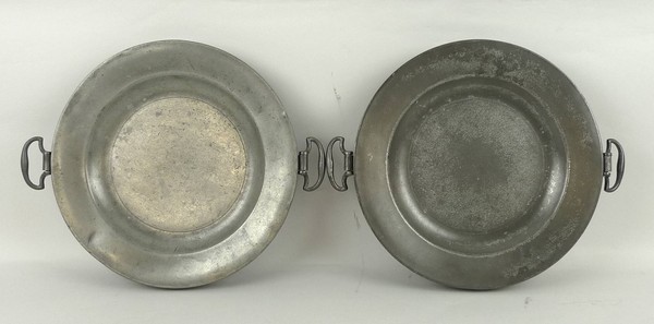 A George III pewter warming plate and another similar, each 24cm diameter.