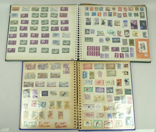 A pair of stamp albums containing world stamps, including three penny reds, and a halfpenny red,