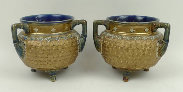 A pair of Royal Doulton stoneware vases, circa 1904, of cauldron form decorated with gilt swirls and