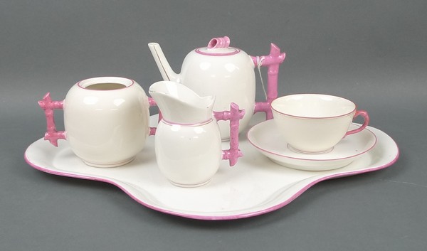 A Continental porcelain solitaire set, early 20th century, decorated with pink bamboo handles,