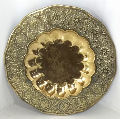 A late 18th / early 19th century Indian brass tray, with scalloped centre, bordered by embossed