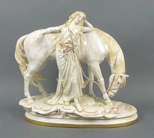 A Scehibe-Alsbach porcelain figure group modelled as a maiden standing against her horse, on a