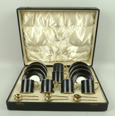 An Allertons porcelain coffee set decorated in black with faux skin, gilt highlighted, comprising