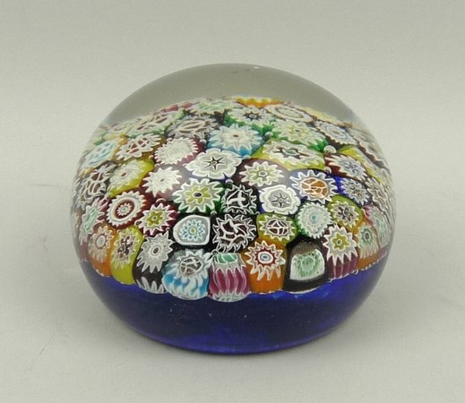 A glass millefiori paperweight, late 19th century, with concentric canes against a blue ground, 9.