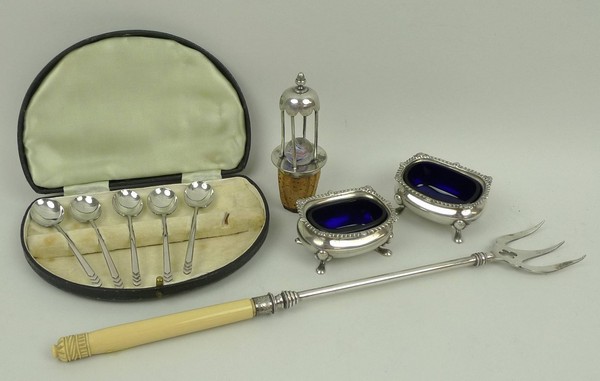 A pair of silver salts with blue glass liners, Birmingham 1920, a set of six silver coffee spoons,