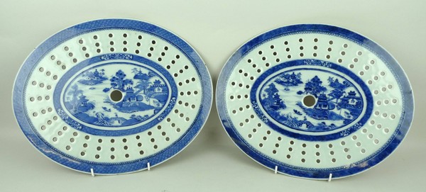 A pair of Chinese export blue and white meat drainers, circa 1800, of oval form decorated in the '