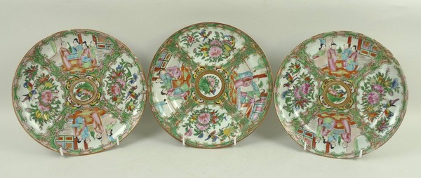 A pair of Canton porcelain plates, 19th century, decorated with reserves of figural and floral