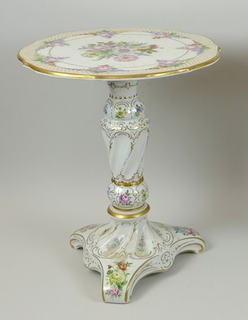 A Plaue porcelain occasional table of fluted, rococo form, painted with flowers, gilt heightened, 36