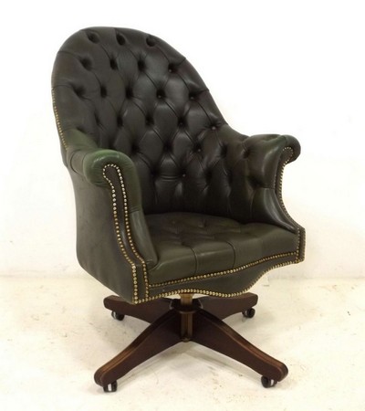 A late 20th century green leather button back swivel chair, 78 by 60 by 102cm high.