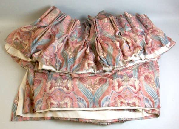 A set of pink full length curtains and pelmet.