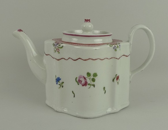 A Newhall porcelain teapot, late 18th Century, of serpentine form painted with sprigs of roses and