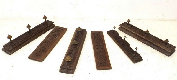 A group of Indian carved hardwood lintels, two depicting birds amidst foliage and one depicting twin